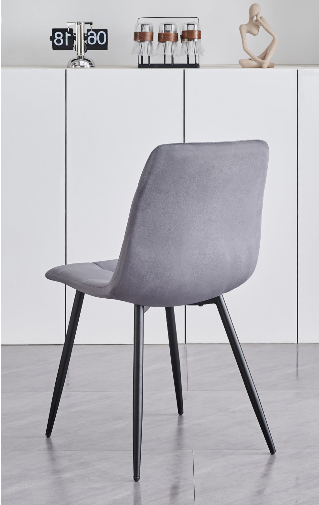 5 Piece White Marble Veneer Top With Black Pedestal Steel Base
Chairs: Soft Grey Velvet with Cross Stitching Details Black Steel Legs
Dimensions
Table: 48"Round 30"H
Chairs: 22"L 18"W 34"H